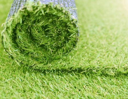 Artificial turf roll. Synthetic grass lawn laying background. Artificial turf roll. Synthetic grass lawn laying background.